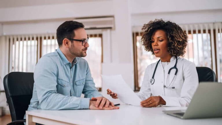 a doctor going over a clients treatment plan