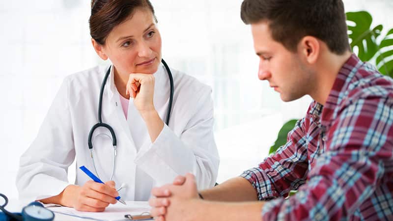 A physician speaks with a patient