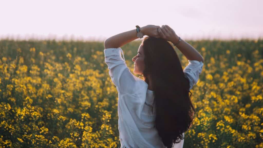 Woman Standing Near Yellow Flowers representing sober person