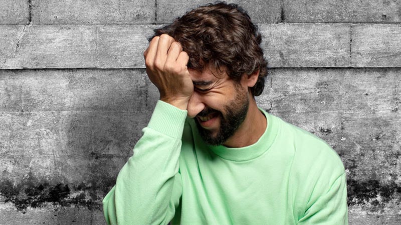 man slapping forehead having memory loss