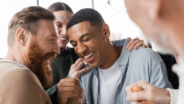 people hugging a man during alcoholics meeting and therapy