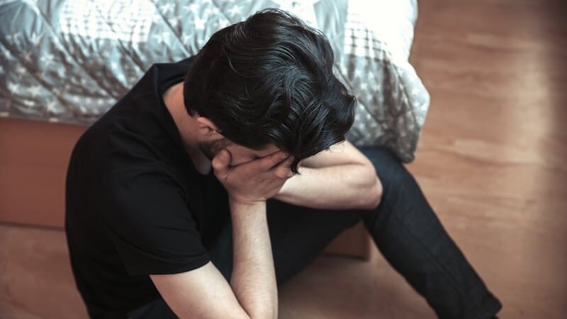 sad man sitting in room