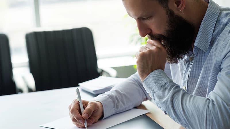 a person writing on a document