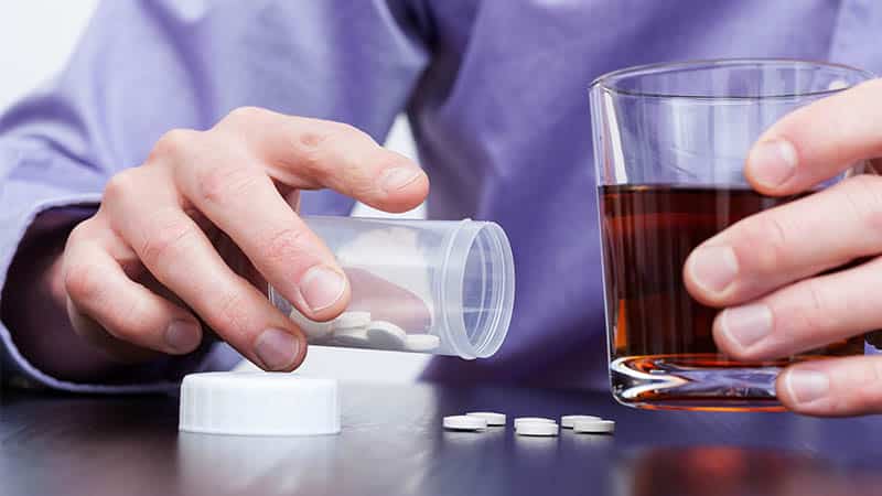 man taking medication and alcohol together