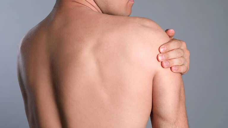 man suffering shoulder pain