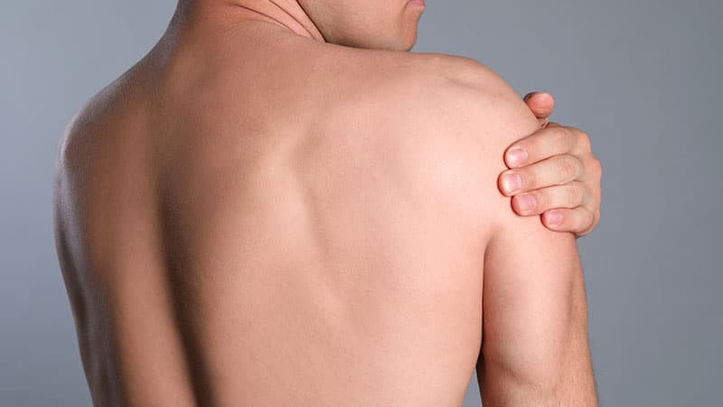 man suffering shoulder pain