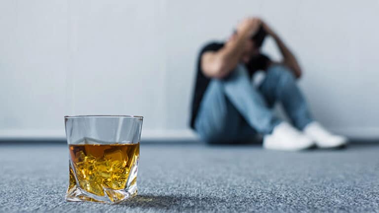 depressed man sitting on floor