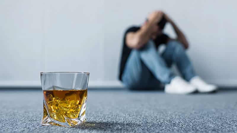 depressed man sitting on floor