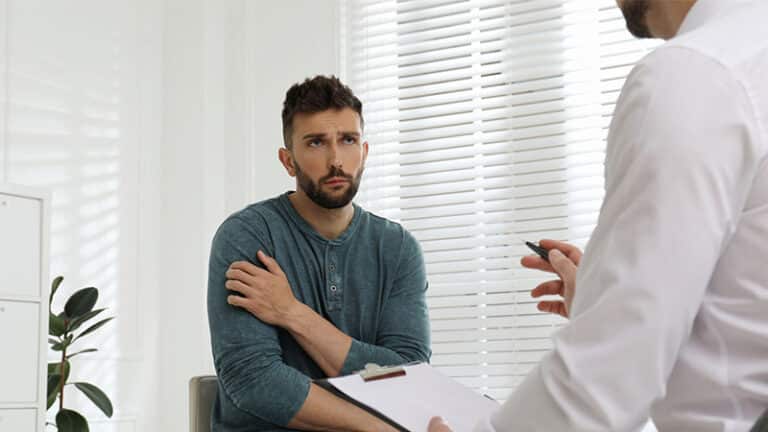 therapist working drug and alcohol addicted man