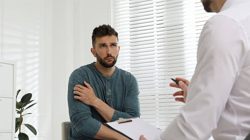 therapist working drug and alcohol addicted man